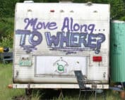 Camper/RV spray painted with the message "move along TO WHERE?"