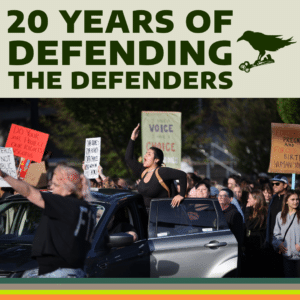 1. A crowd of people gathered in Eugene, Oregon protest the Supreme Court decision to overturn Roe v. Wade. A femme person is pictured at center yelling and standing on a car amid the crowd of people marching and holding signs. The CLDC logo appears at top alongside text that reads “20 YEARS OF DEFENDING THE DEFENDERS”